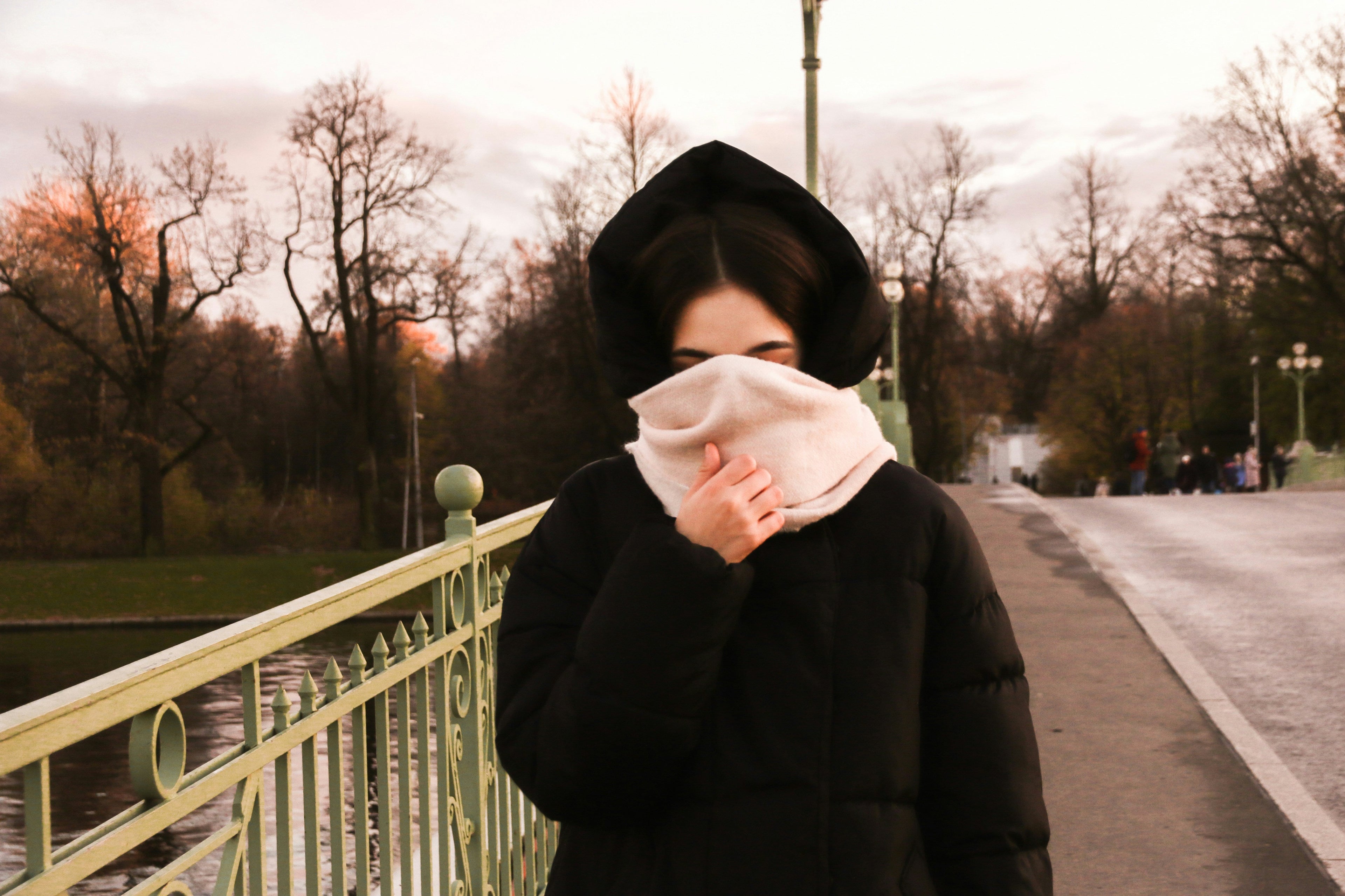 woman covering face with scarf